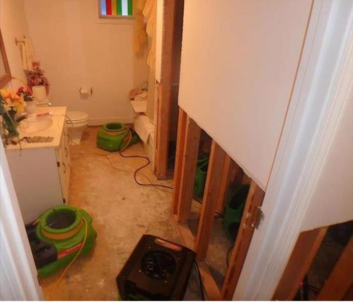 studs showing, removed wall, equipment drying bathroom